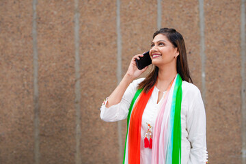 Happy Indian woman talking on smartphone.