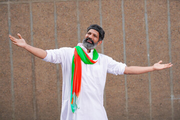 Indian man in traditional wear and giving expression.