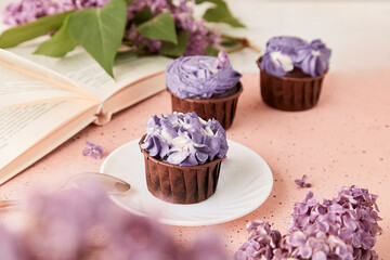 Aesthetic french purple floral cupcakes using trend Dreamy Escapism. Coffee time among lilac...
