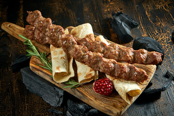 Lamb Lyulya kebab with pita on wooden board. Turkish food