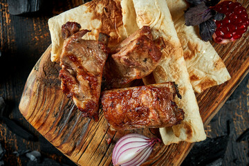 Pork shish kebab on wooden board. Turkish food. Pork grilled on a charcoal barbecue