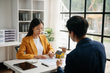 Signing a contract. Client and broker agent, lease agreement, successful deal and  Young business sitting at the desk in office .