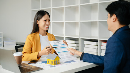  Signing a contract. Client and broker agent, lease agreement, successful deal and  Young business sitting at the desk in office .