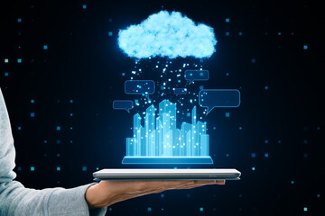 Internet of things in smart city and mobile cloud service concept with graphic city skyscrapers, pixel rain and blue cloud on human hand with digital tablet on dark technological background