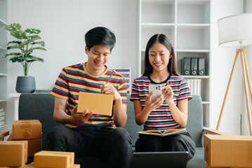 young Asian man and woman at office of their business online shopping.In home office.