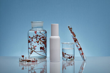 On the backlit background, a white cosmetic bottle unbranded decorated with lab equipments...