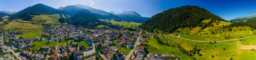 South Tirol village embedded in green mountain landscape from top