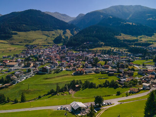 South Tirol village embedded in green mountain landscape from top