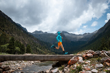 Woman trail runner cross country running in high altitude mountains