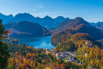 Fototapeta na wymiar lake mountains and european town with blue sky in autumn time