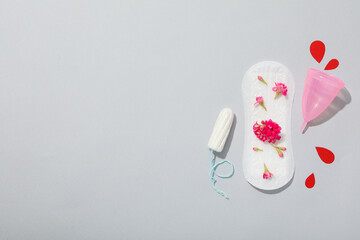 Menstrual pad with flowers on a gray background