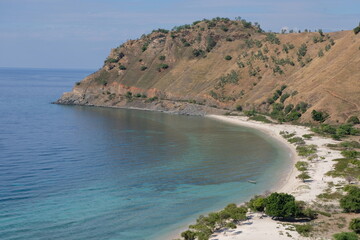 Beautiful white sandy beach and turquoise ocean water of Cristo Rei back beach in capital city of Dili, Timor-Leste, Southeast Asia