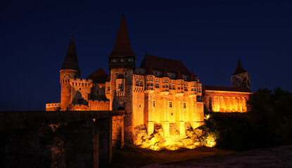Fototapeta na wymiar Corvin (Hunyad) Castle in Hunedoara during the evening. Wide angle night phoot with this amazing medieval castle landmark in Romania.