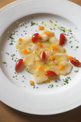 Scallop crudo with tomatoes and herbs