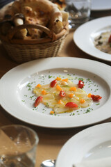 Scallop crudo with tomatoes and herbs