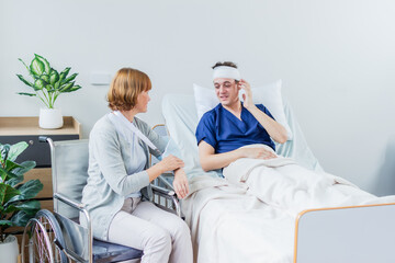 Obraz premium The patient has a headache while lying in the hospital room with Gauze Bandage Wrapped Around Head.