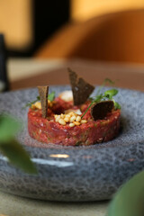 Traditional steak tartare with pine nuts