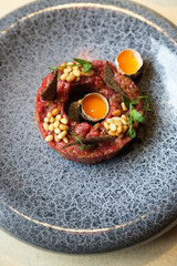 Traditional steak tartare with pine nuts