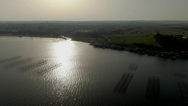Aerial panorama of dron flying from oyster farms near Sete city on the salt lake