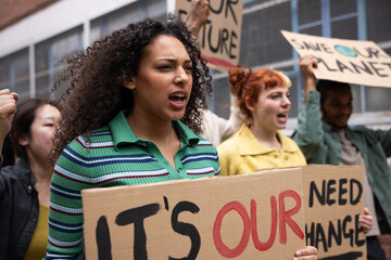Young adult female shouting at a climate change protest