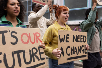 Young adult female campaigner shouting at a demonstration