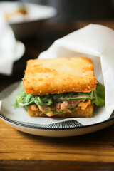Deep fried fish burger with spinach