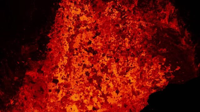 Extreme close up of molten lava exploding from active volcano crater