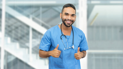 Motivated mexican male nurse or doctor with beard and stethoscope showing thumbs up