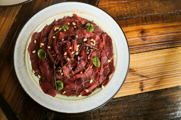 Venison carpaccio with pine nuts