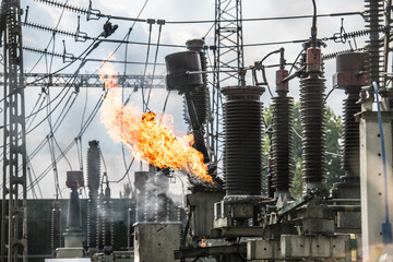 Transformer explosion in power plant. High-voltage insulator on fire.