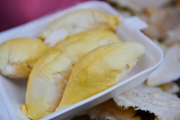 Close-up of hand holding fresh ripe durian peeled