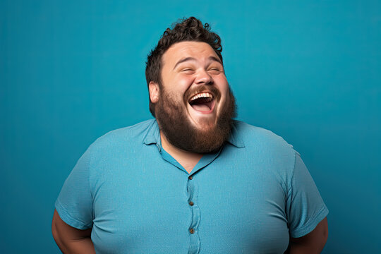 Excited fat man celebrating success. Happy plus size bearded man on blue background