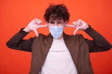 Illness and health problems. Funny guy posing on an orange background.