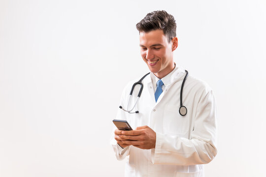 Image of young doctor using phone.	