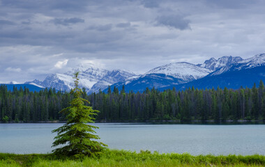 Fototapeta na wymiar Annette Lake with snow-capped mountains in Jasper National Park, Canada.