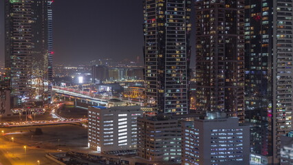 Fototapeta na wymiar Business bay district skyline with modern architecture night timelapse from above.