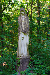 Sculpture of a mourning woman on a gravesite in the southwest churchyard Stahnsdorf. The cemetery is a famous woodland cemetery in the federal state of Brandenburg in the south of Berlin