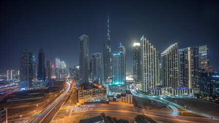 Aerial panoramic view of Dubai Downtown skyline with many towers all night timelapse.