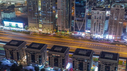 Fototapeta na wymiar Buildings on Sheikh Zayed Road in Dubai aerial night timelapse, UAE.