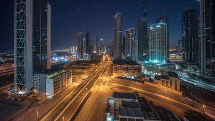 Fototapeta na wymiar Aerial view of Dubai Downtown skyline with many towers night to day timelapse.