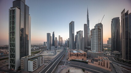 Aerial view of Dubai Downtown skyline during sunrise with many towers timelapse.
