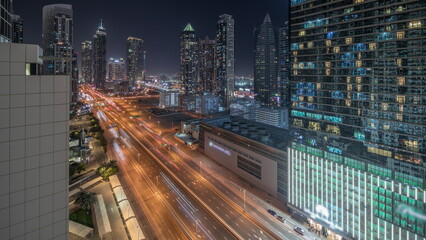 Naklejka premium Panorama showing business bay district skyline with modern architecture night timelapse from above.