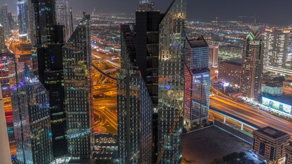 High-rise buildings on Sheikh Zayed Road in Dubai aerial night timelapse, UAE.