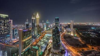 Fototapeta premium Skyline panoramic view of the high-rise buildings on Sheikh Zayed Road in Dubai aerial night timelapse, UAE.