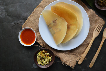 dosa masala. Paper Masala dosa is a South Indian meal served with sambar and coconut chutney over fresh banana leaf.