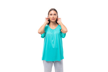 young brunette european lady with straight hair dressed in blue t-shirt isolated on white background in copy space