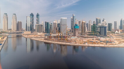 Fototapeta premium Cityscape with skyscrapers of Dubai Business Bay and water canal aerial timelapse.