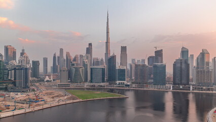 Fototapeta premium Aerial view to Dubai Business Bay and Downtown with the various skyscrapers and towers timelapse