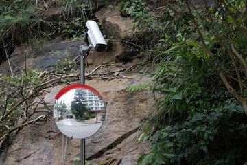 The surveillance camera, along with the rearview mirror, is installed on the side of the mountain,...