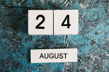 Wooden calendar on a dark background. Independence Day of Ukraine. National Waffle Day in the USA